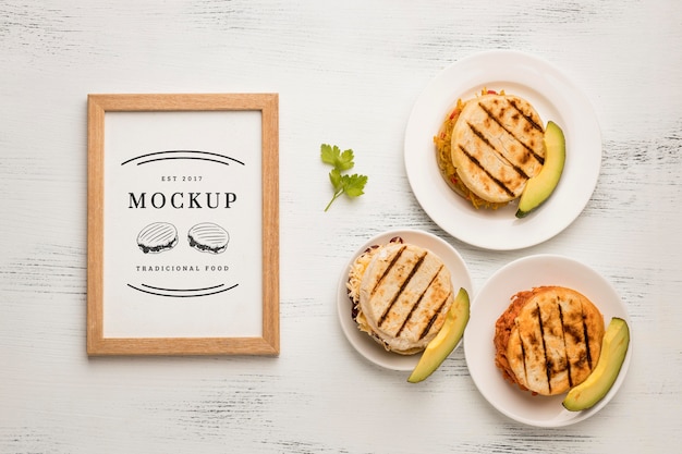 PSD frame mock-up and delicious sandwiches flat lay