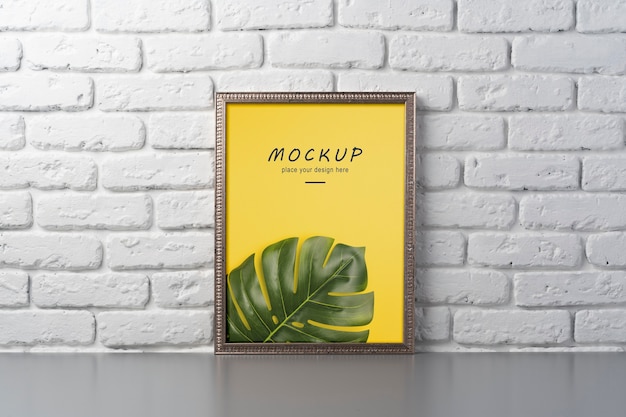 PSD frame mockup hanged on brick wall