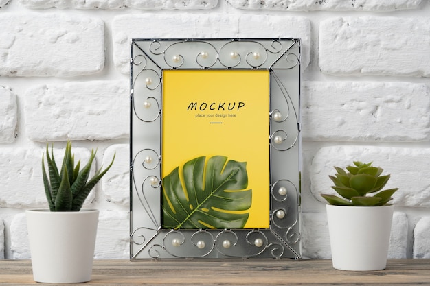 PSD frame mockup hanged on brick wall