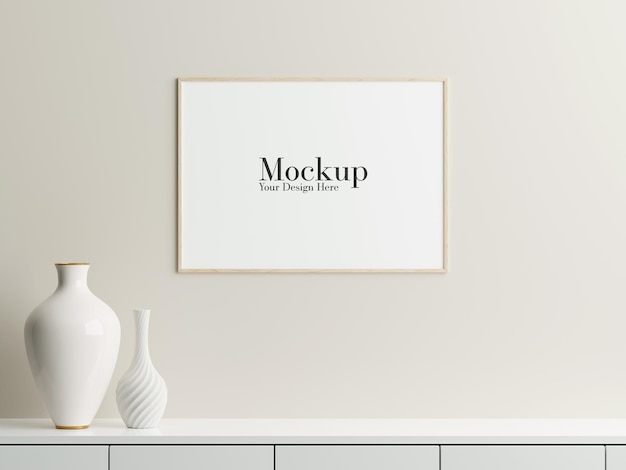 Frame mockup hanging on the wall with decorative vase on top of table