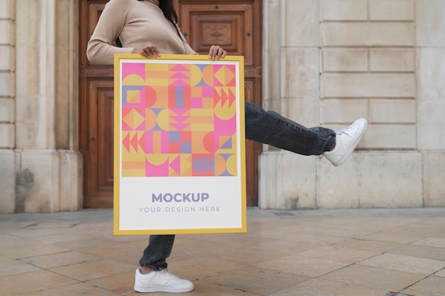 Frame mockup held by person outside