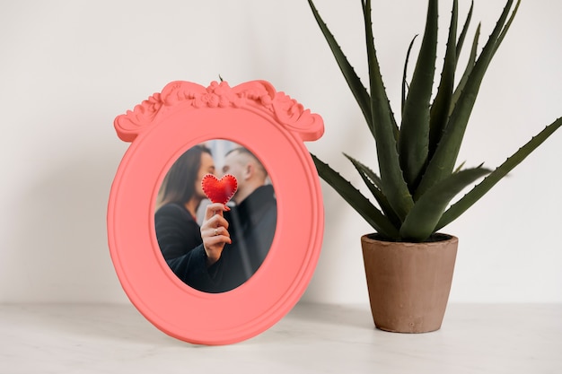 Frame mockup next to a plant