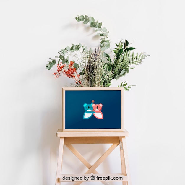 PSD frame mockup on stool with flowers