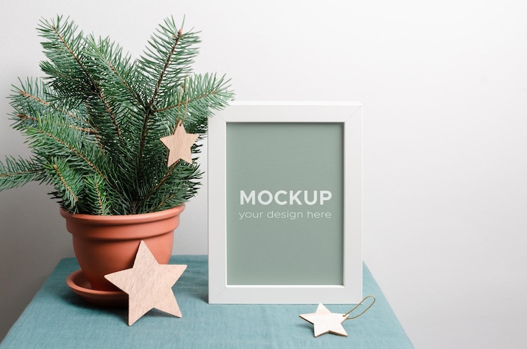 PSD frame mockup with fir tree branches in terracotta pot and wooden stars over white wall