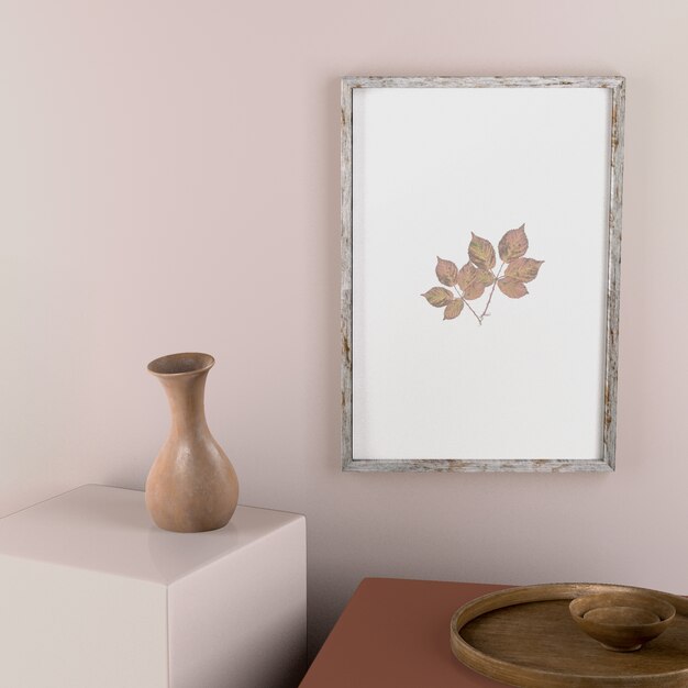 Frame on wall with leaves and vase decor