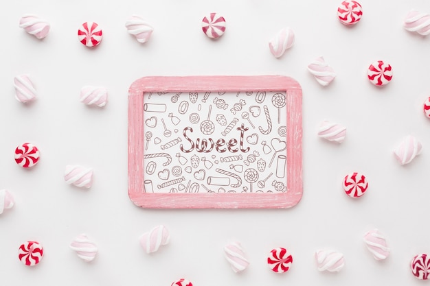 Frame with delicious candies beside