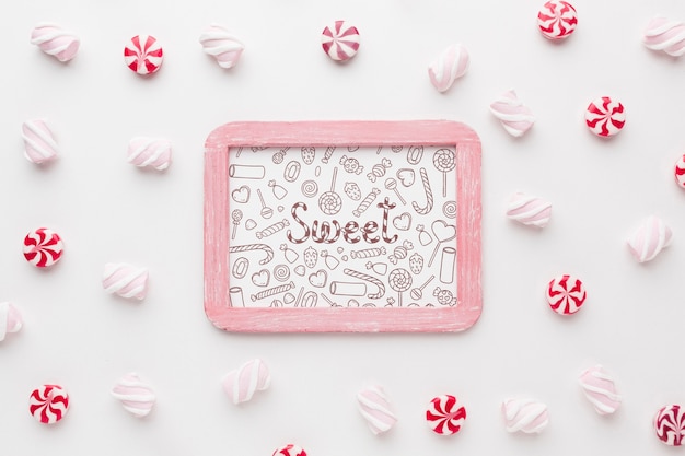 PSD frame with delicious candies beside