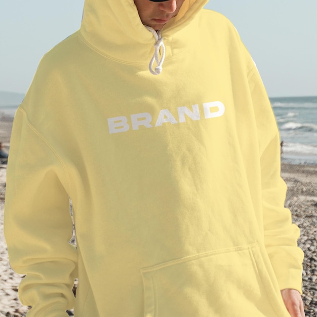 Free editable mock-up front view of stylish man in light yellow hoodie for your brand