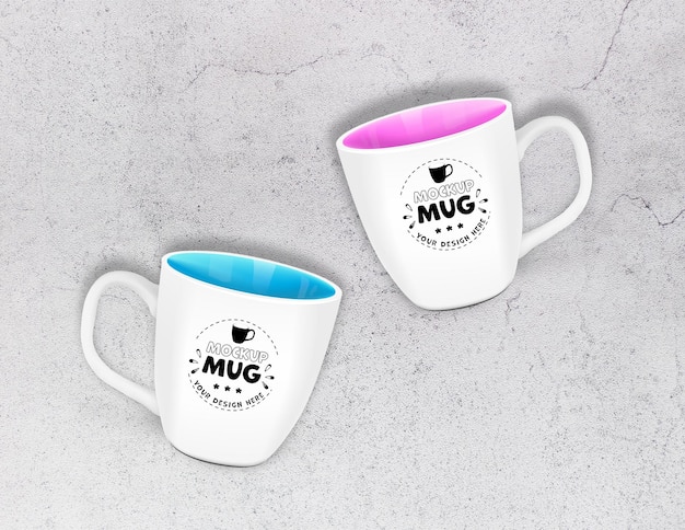 Free PSD mockup two mugs with a pink and blue rim on raw concrete background