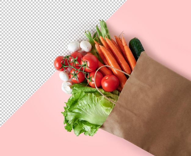 コピースペースとピンクの背景にリサイクル可能な紙袋に新鮮な野菜