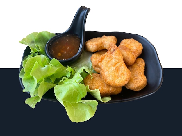 PSD fried chicken nuggets with dipping sauce in black dish