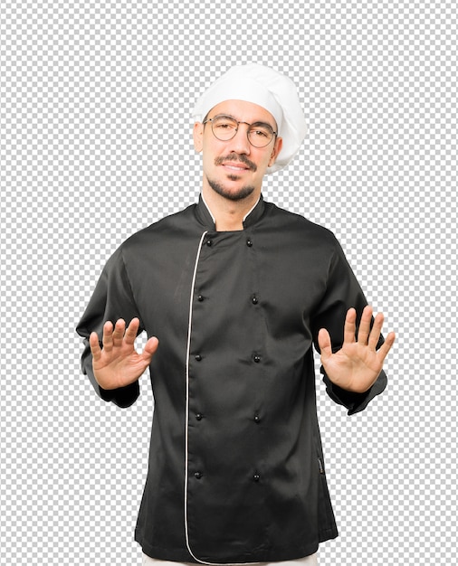 Friendly young chef doing a gesture of keep calm