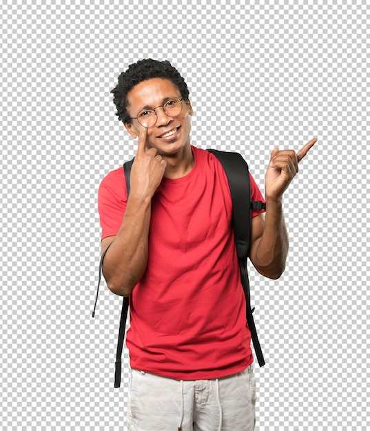 PSD friendly young man making a gesture of being careful with his hand pointing at his eye