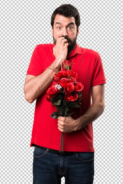 恐ろしいハンサムな男の花を保持