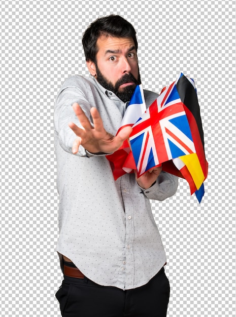 PSD frightened handsome man with beard holding many flags