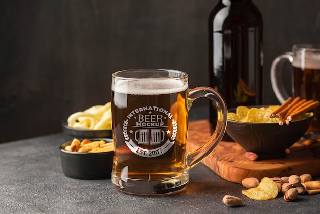 front view of beer pint with assortment of snacks