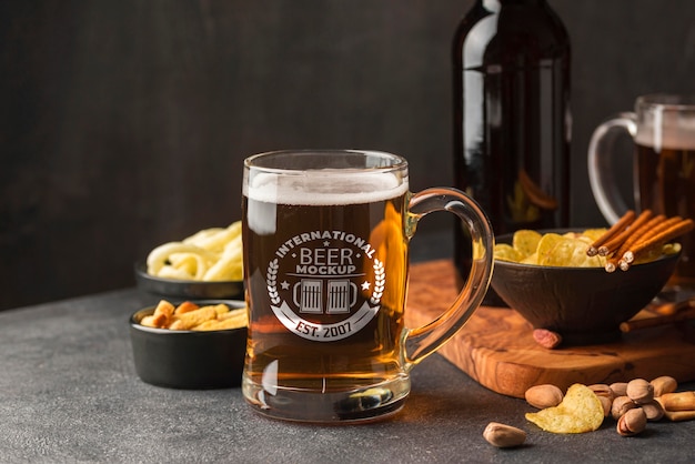 Front view of beer pint with assortment of snacks