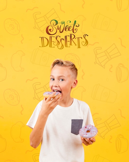 Front view of child eating a donut