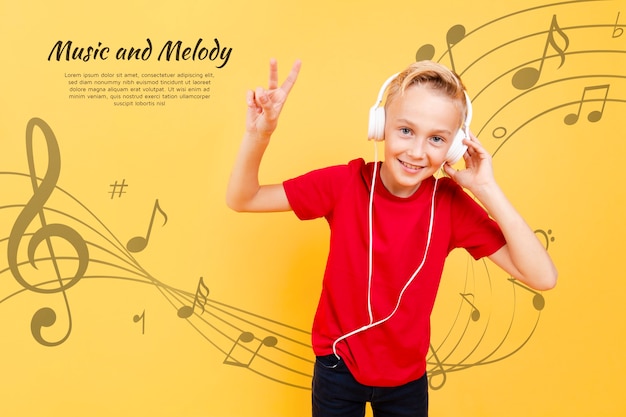Front view of child listening to music on headphones and making peace sign