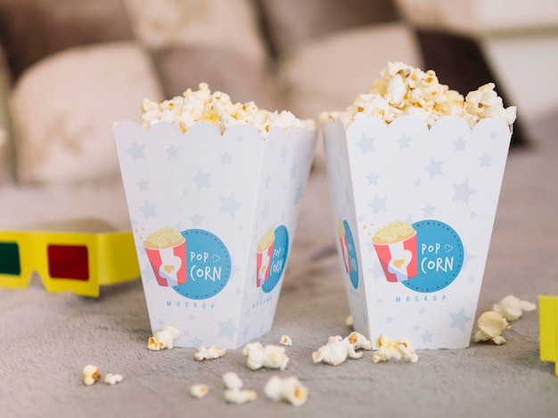 Front view of cinema glasses and popcorn cups