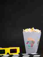 PSD front view of cinema glasses with popcorn and copy space