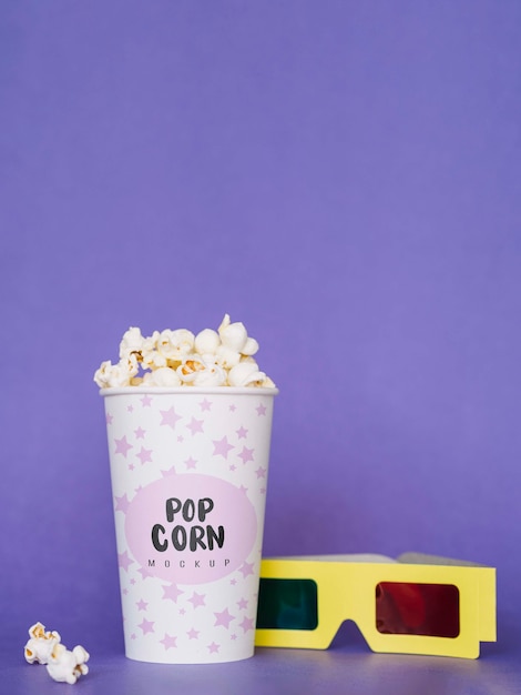 front view of cinema popcorn and glasses
