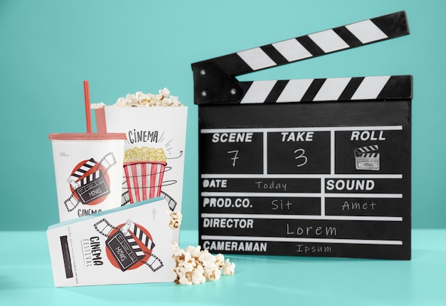 Front view of cinema popcorn with cup and clapperboard