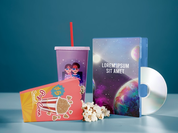 PSD front view of cinema popcorn with cup and dvd