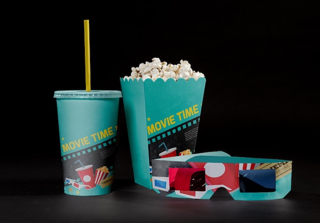 front view of cinema popcorn with threedimensional glasses and cup