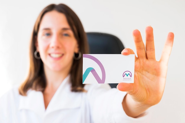 front view of defocused businesswoman holding business card