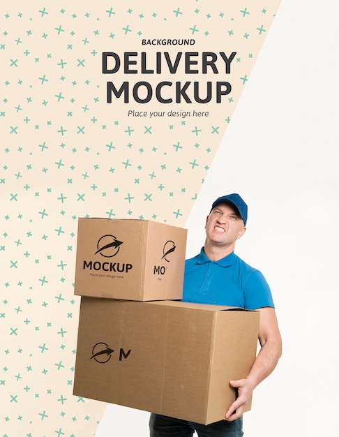 Front view delivery man holding a bunch of boxes with background mock-up