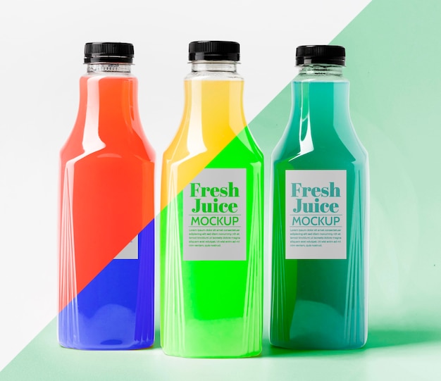 Front view of different transparent juice bottles with caps