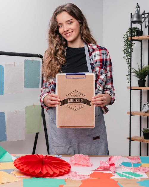 Front view of female artist holding notepad