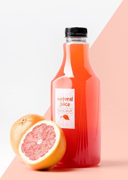 PSD front view glass juice bottle with grapefruits