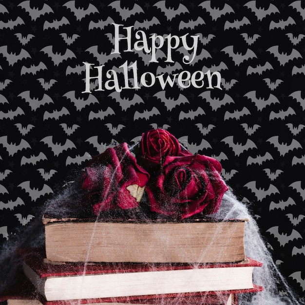 Vista frontale del concetto di halloween con fiori e libri