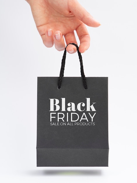 PSD front view of hand holding black friday bag concept