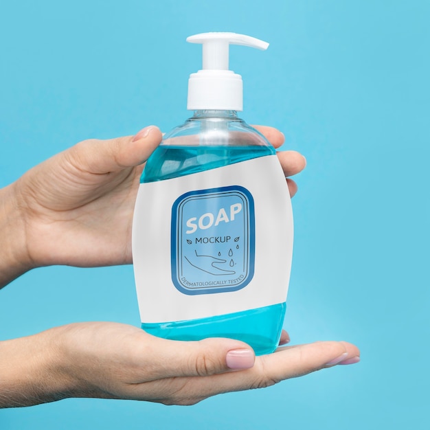 PSD front view of hands holding bottle of liquid soap