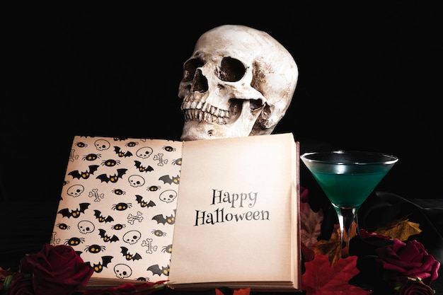 Front view of skull and book on leaves