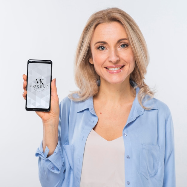 PSD front view of smiley blonde woman holding smartphone