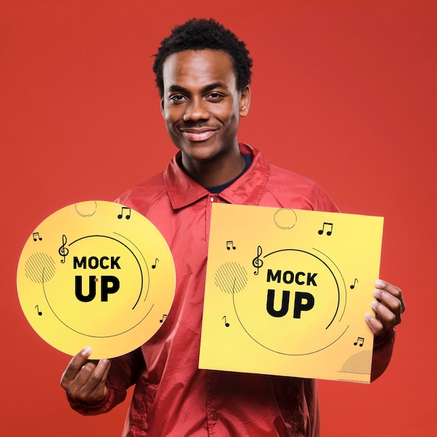 PSD front view of smiley man holding vinyl disk for music store mock-up