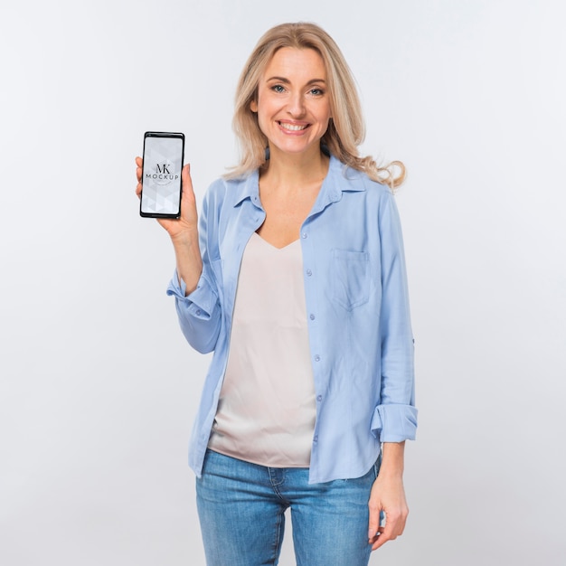 Front view of smiley woman holding smartphone