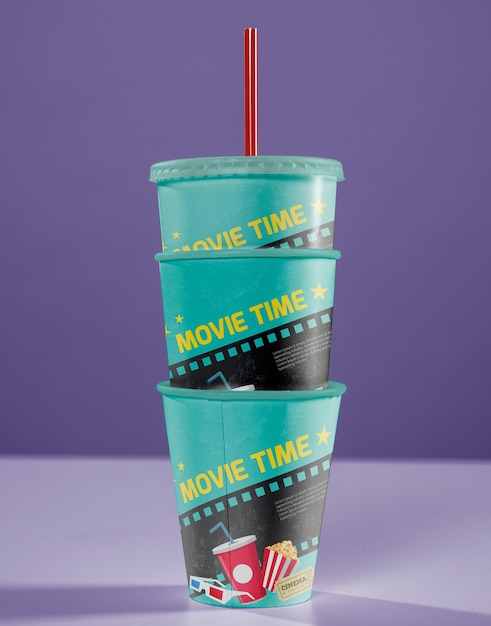 Front view of stacked cinema cups with straw