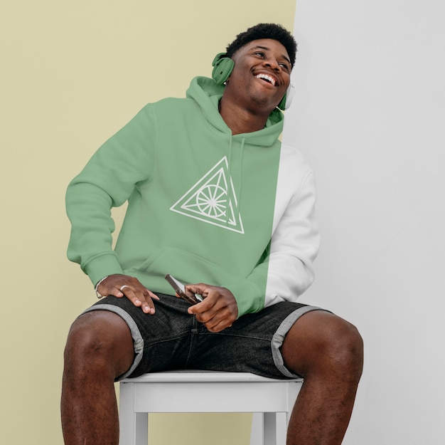front view of stylish man in hoodie with headphones