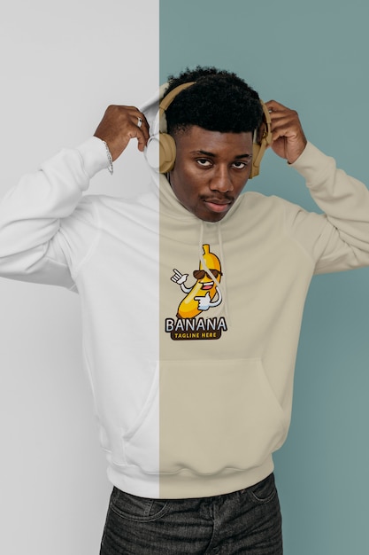 front view of stylish man in hoodie with headphones