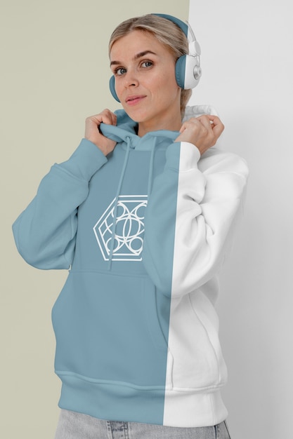 Front view of stylish woman in hoodie with headphones