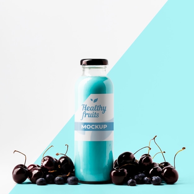 PSD front view of transparent juice bottle with cherries