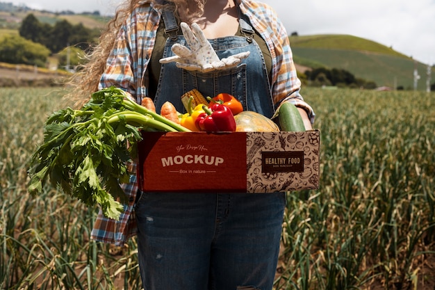 PSD front view woman  holding a box in nature