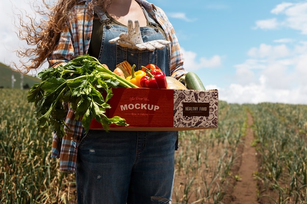 PSD front view woman  holding a box in nature