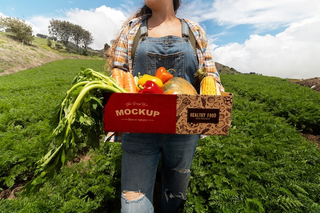 PSD front view woman  holding a box in nature