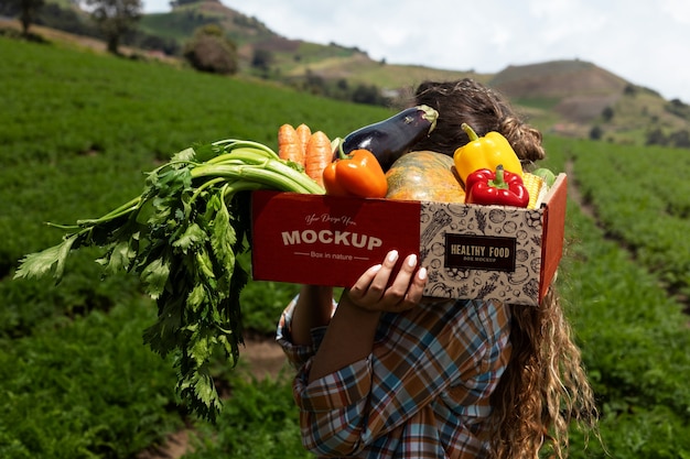 PSD front view woman  holding a box in nature